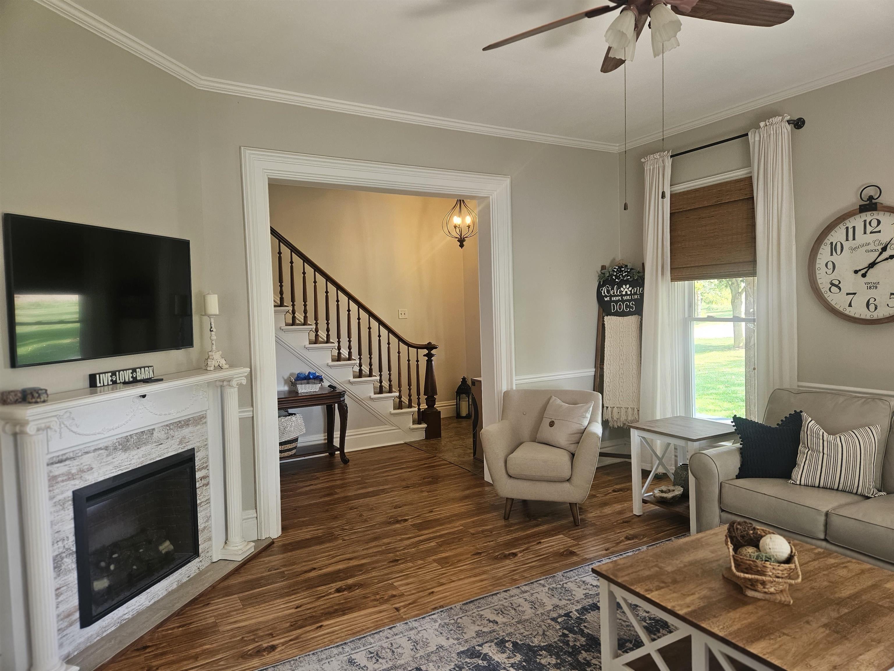 1851 West Winneshiek Road Freeport, IL 61032 - Photo 4 of 41 a living room with furniture a flat screen tv and a fireplace