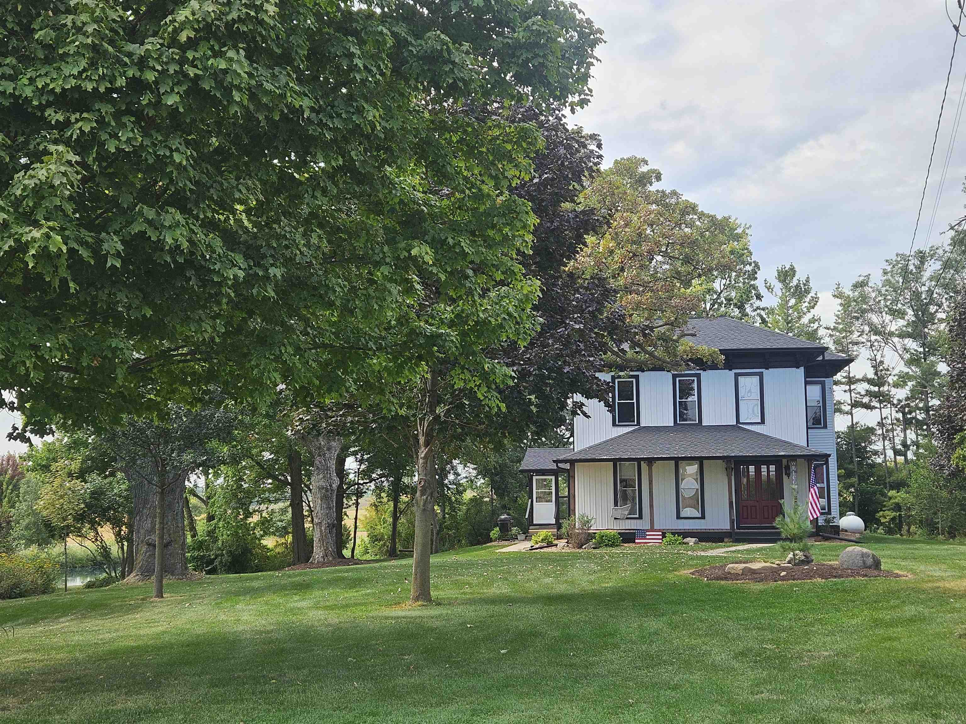 1851 West Winneshiek Road Freeport, IL 61032 - Photo 41 of 41 a view of a big house with a big yard and large trees