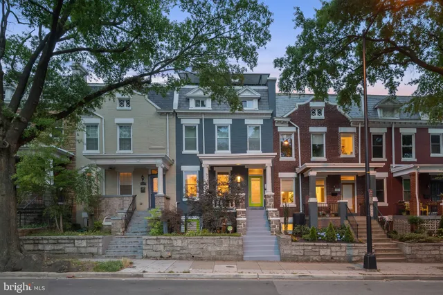 a front view of a residential apartment building with a yard