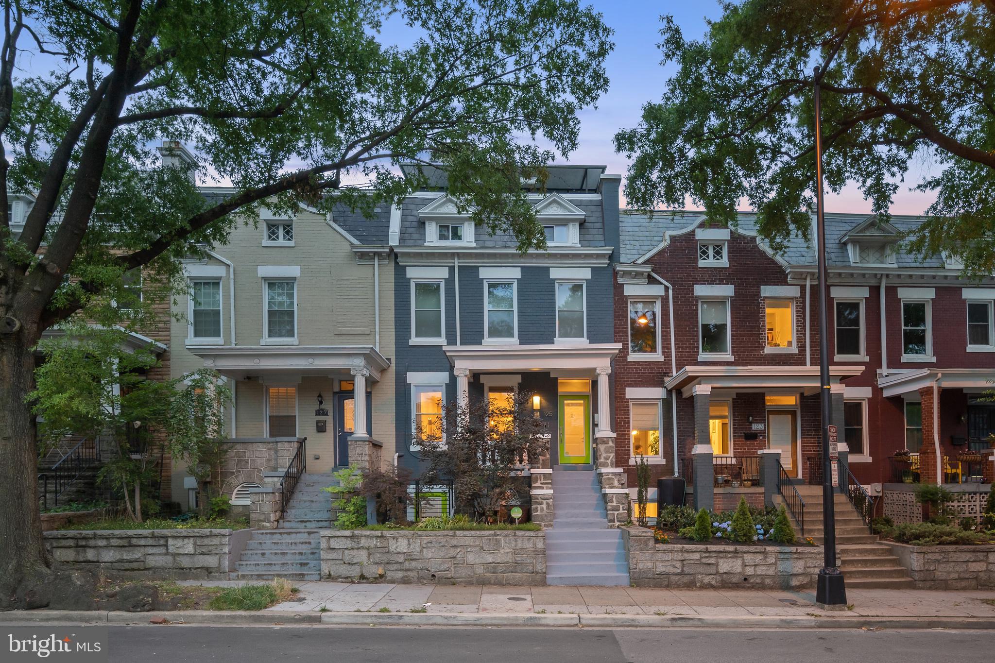a front view of a residential apartment building with a yard