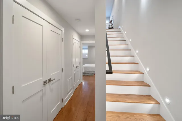 a view of entryway and hall with wooden floor