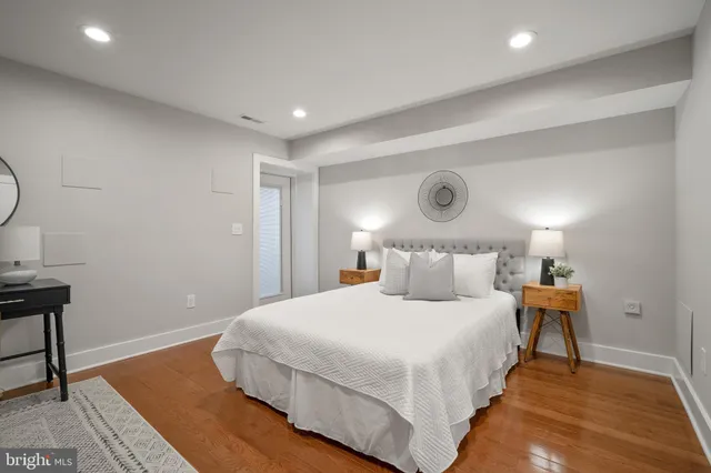 a bedroom with a bed and lamps on the table