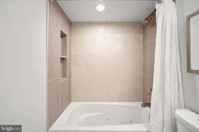 a bathroom with a bathtub and a shower