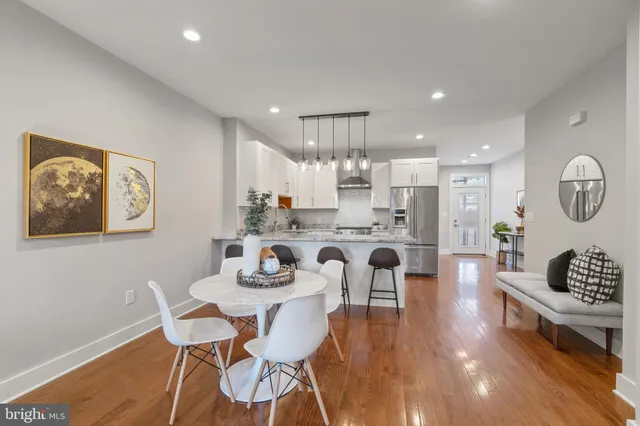 a living room with kitchen island furniture and a wooden floor