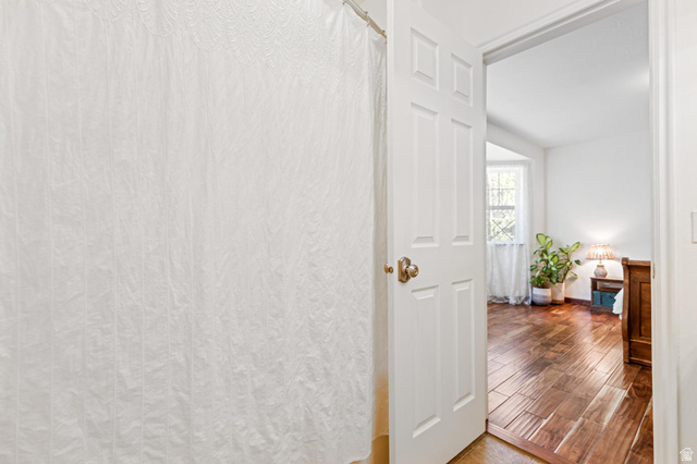 814 Mountain Road Logan, UT 84321 - Photo 14 of 42 White paneled door opening to a room with wood-finish flooring