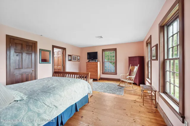 a bedroom with a large bed and a window