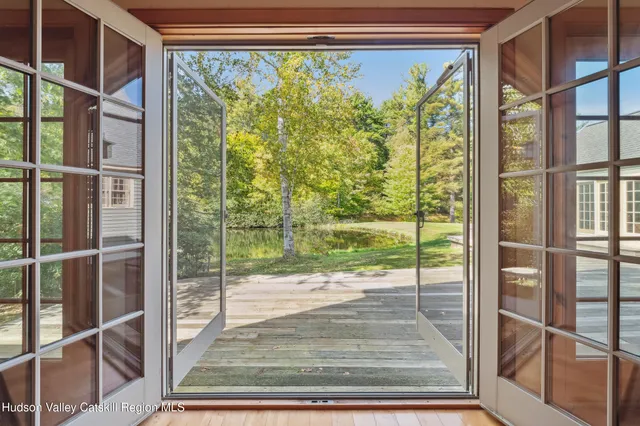a view of a room with wooden floor and windows