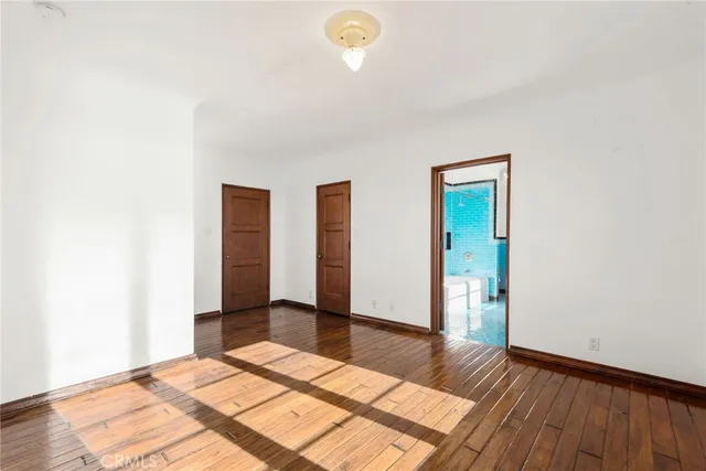 a bathroom with a white bath tub a sink and a mirror