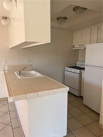 an empty room with a window and a ceiling fan