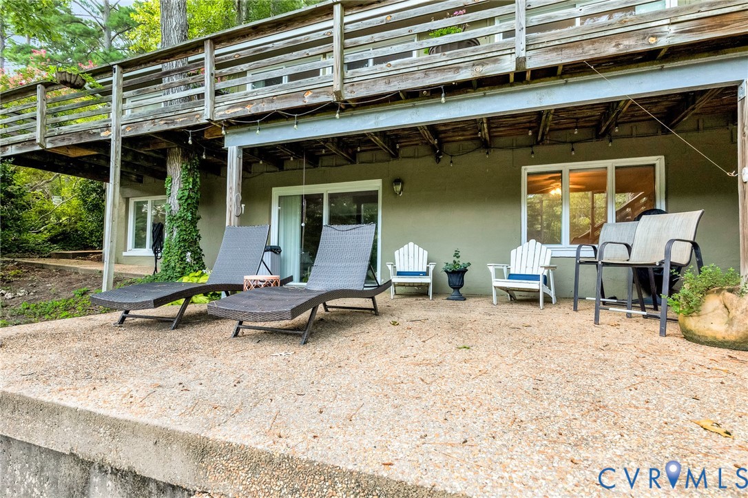 200 Pond Road Lancaster, VA 22503 - Photo 14 of 48 a view of a lounge chair on the deck in front of house