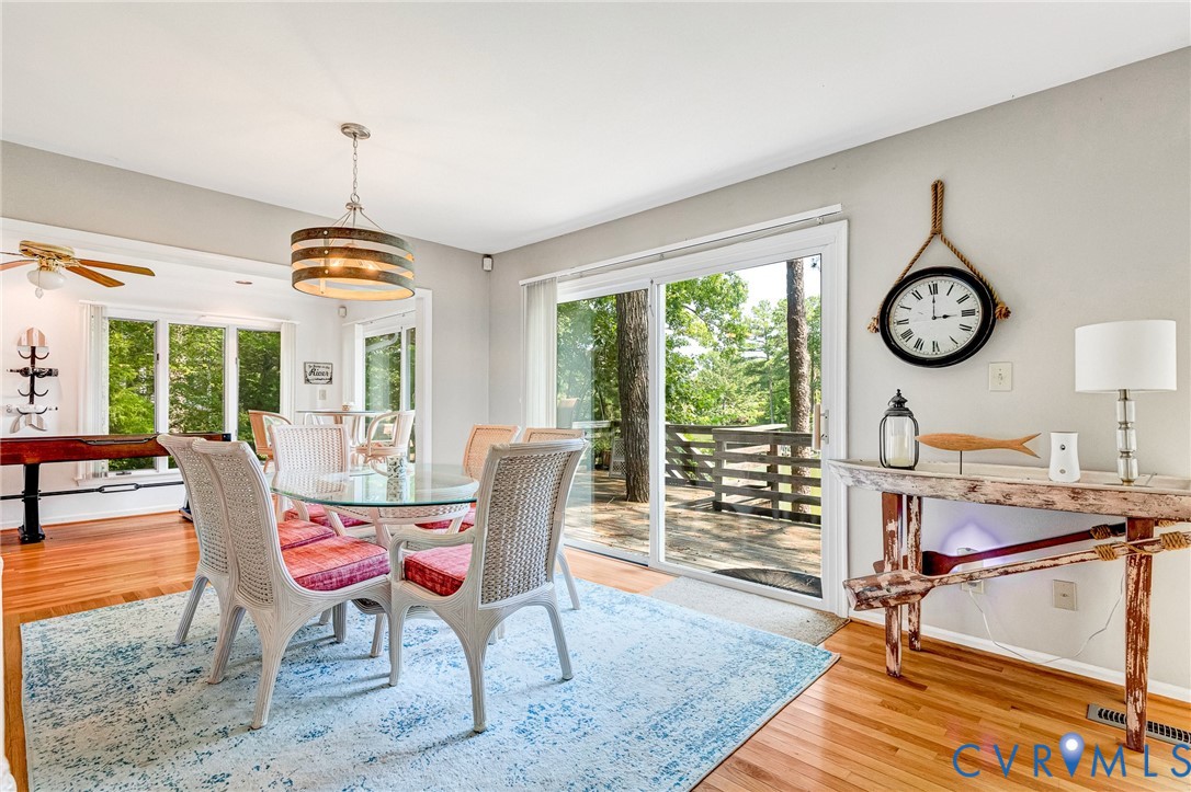 200 Pond Road Lancaster, VA 22503 - Photo 26 of 48 a dining room with furniture a clock and a large window