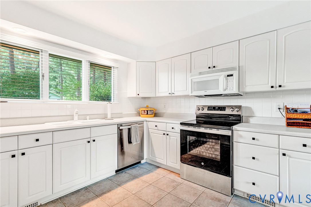 200 Pond Road Lancaster, VA 22503 - Photo 29 of 48 a kitchen with cabinets appliances and a window