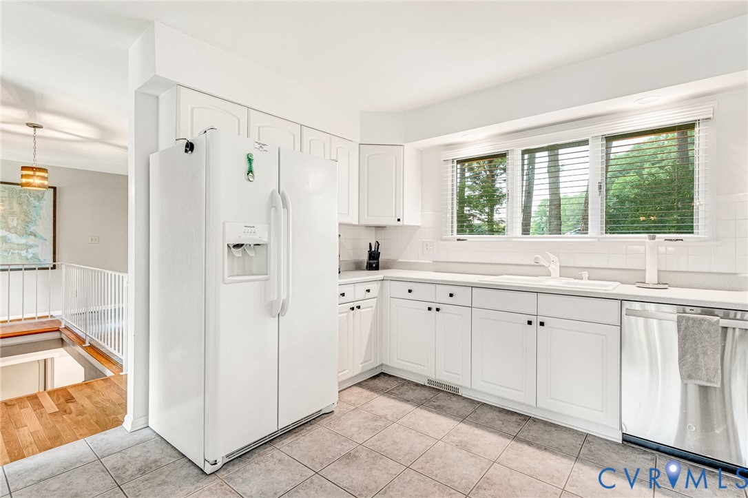 200 Pond Road Lancaster, VA 22503 - Photo 30 of 48 a kitchen with white cabinets and window
