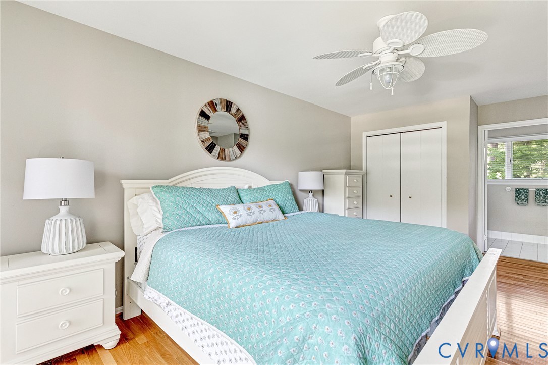 200 Pond Road Lancaster, VA 22503 - Photo 34 of 48 a bedroom with a bed and a chandelier