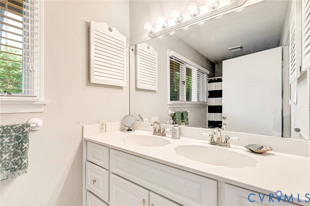 200 Pond Road Lancaster, VA 22503 - Photo 35 of 48 a bathroom with a sink and a mirror