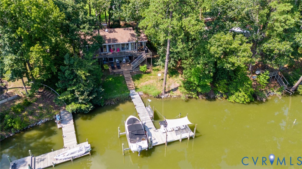 200 Pond Road Lancaster, VA 22503 - Photo 8 of 48 a aerial view of a house with pool yard lake and trees in the background
