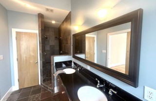 1045 Bonner Street Houston, TX 77007 - Photo 11 of 14 a bathroom with a sink mirror and a shower