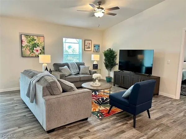 a kitchen with stainless steel appliances granite countertop a dining table chairs refrigerator a sink and dishwasher