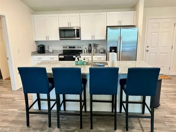a living room with kitchen island furniture and a wooden floor