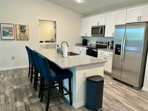 a room with pool table and windows