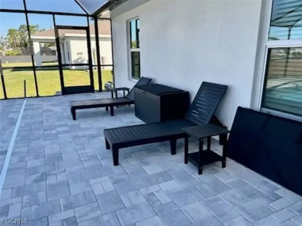 a view of a chairs and table in the patio