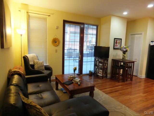11 West 2nd Street, Unit 141 Bethlehem, PA 18015 - Photo 3 of 12 a living room with furniture and a flat screen tv with wooden floor