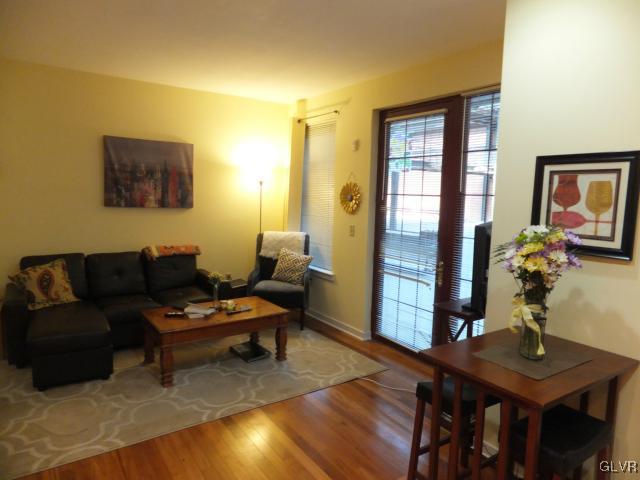11 West 2nd Street, Unit 141 Bethlehem, PA 18015 - Photo 4 of 12 a living room with furniture and wooden floor