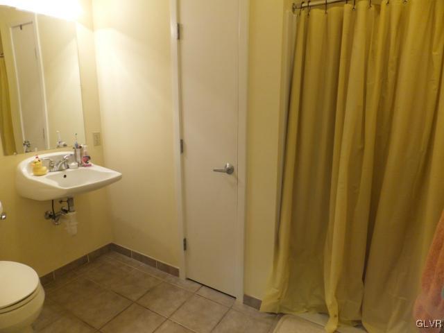 11 West 2nd Street, Unit 141 Bethlehem, PA 18015 - Photo 9 of 12 a bathroom with a sink a toilet and shower
