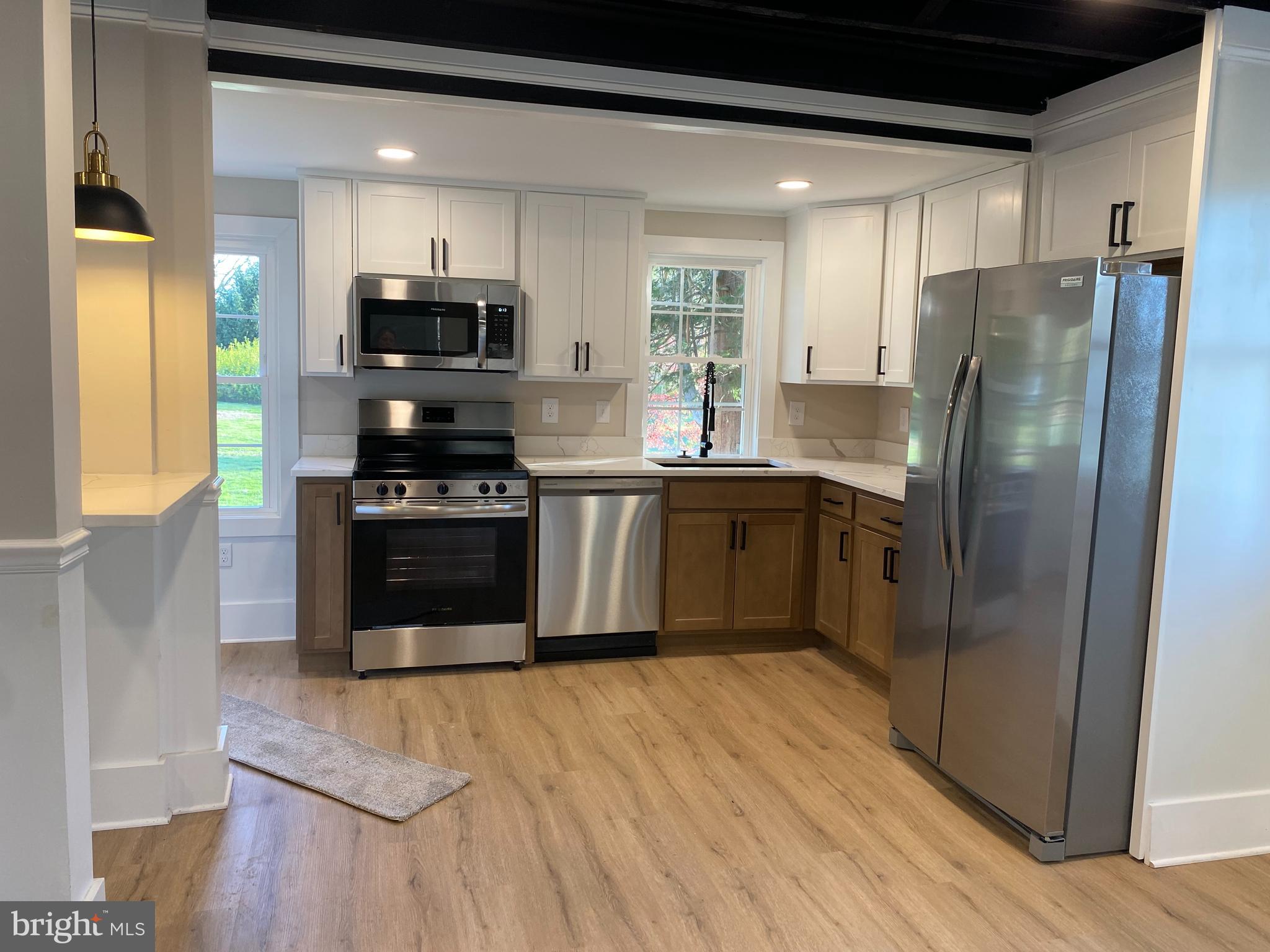 10141 Liberty Road, Unit 1 Randallstown, MD 21133 - Photo 13 of 21 a kitchen with stainless steel appliances granite countertop a stove a sink and a refrigerator