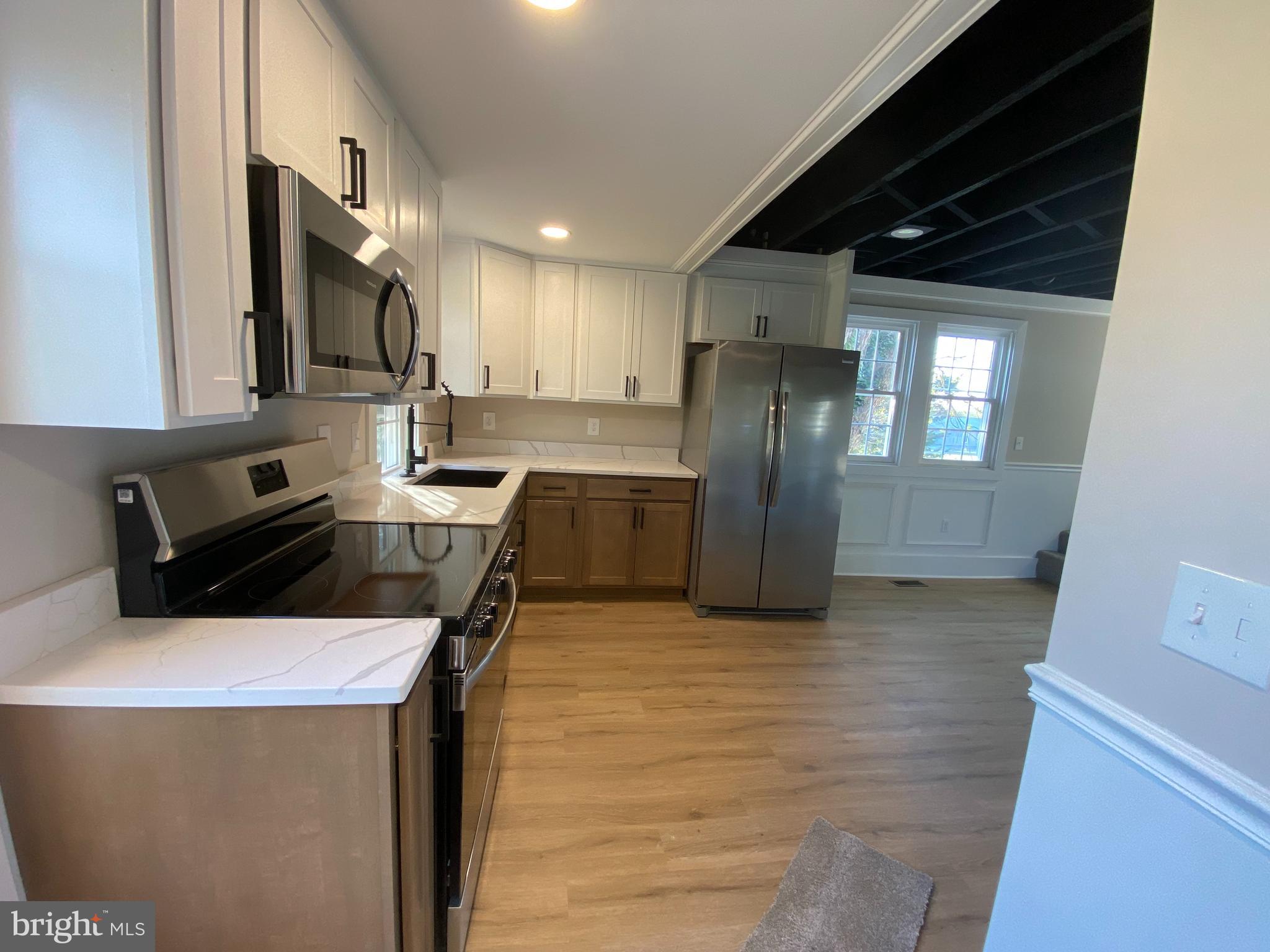 10141 Liberty Road, Unit 1 Randallstown, MD 21133 - Photo 14 of 21 a kitchen with stainless steel appliances a refrigerator a sink a stove and cabinets
