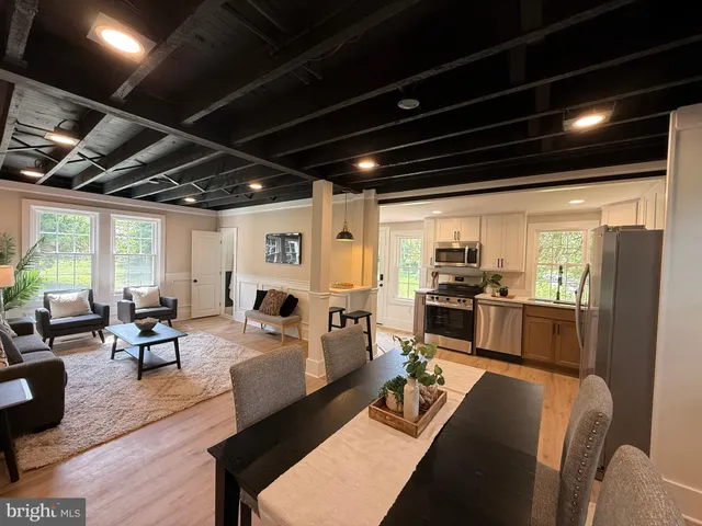 a living room with lots of furniture and kitchen view