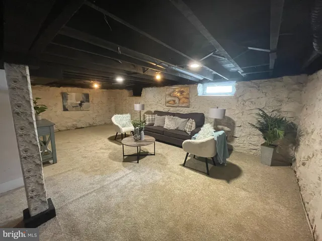 a building outdoor space with patio furniture and potted plants