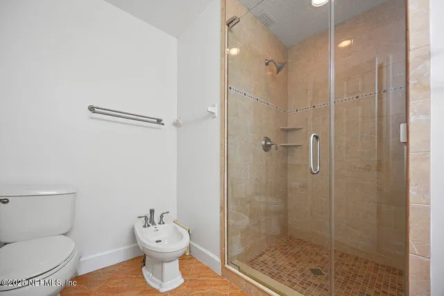 a bathroom with a shower sink and mirror