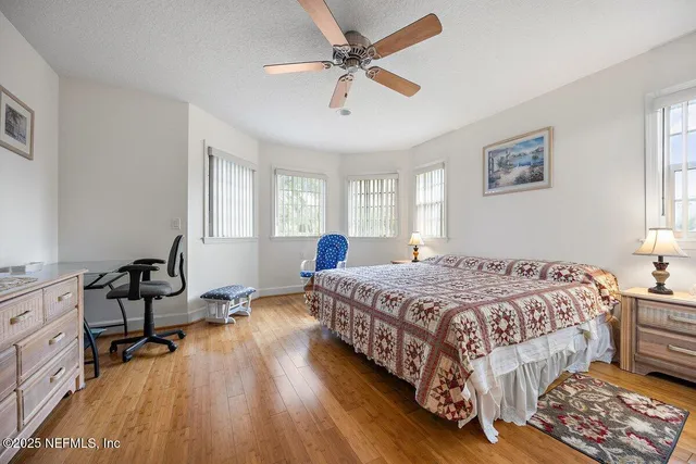 a spacious bathroom with a granite countertop sink toilet and shower