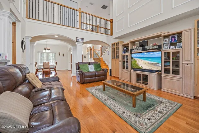 a kitchen with stainless steel appliances granite countertop a table chairs and a refrigerator