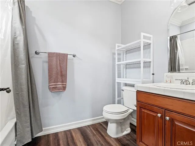 a bathroom with a toilet sink and shower