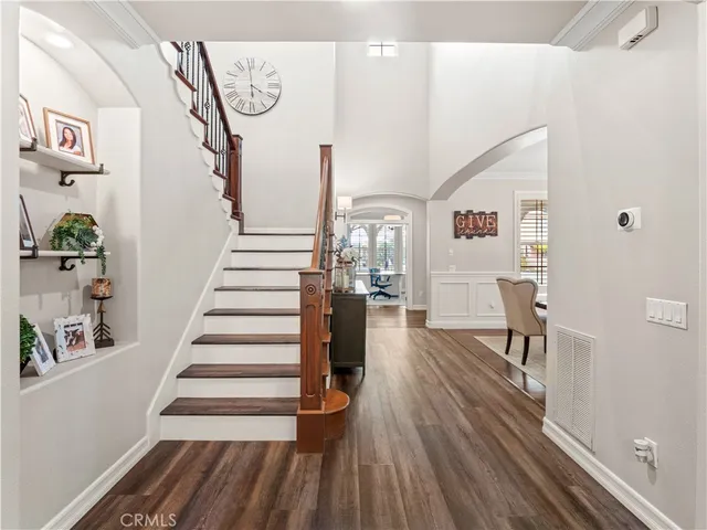 a view of entryway and hall with wooden floor