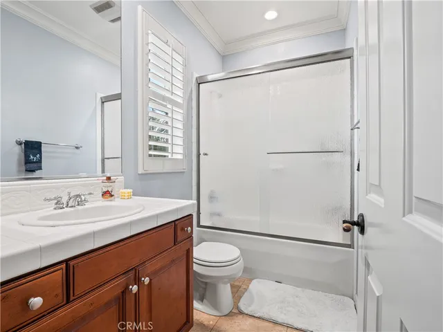 a bedroom with a bed a table and a lamp