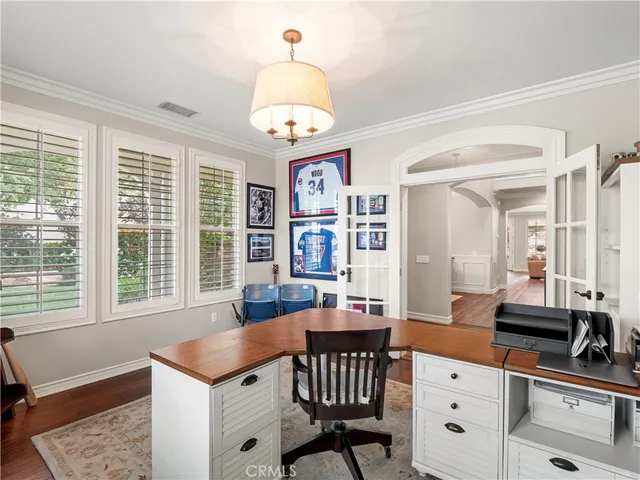 a kitchen that has a table chairs in it and wooden floors