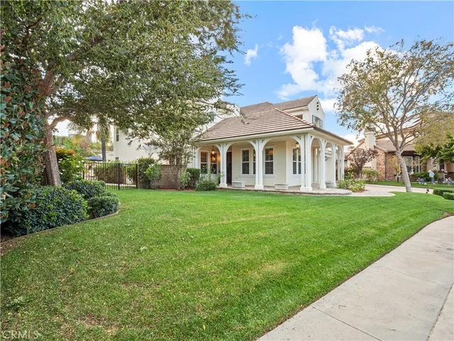 an aerial view of a residential houses with outdoor space and trees