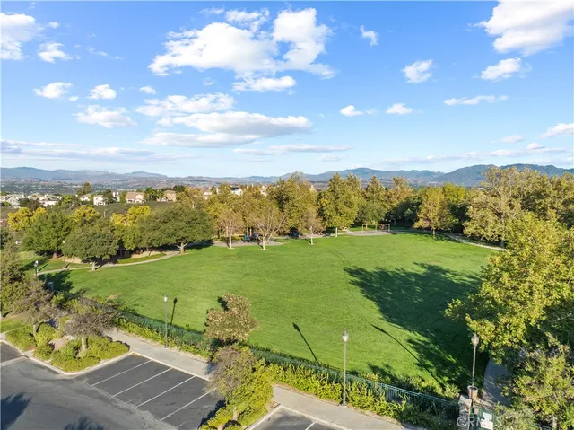 an aerial view of residential houses with outdoor space and trees