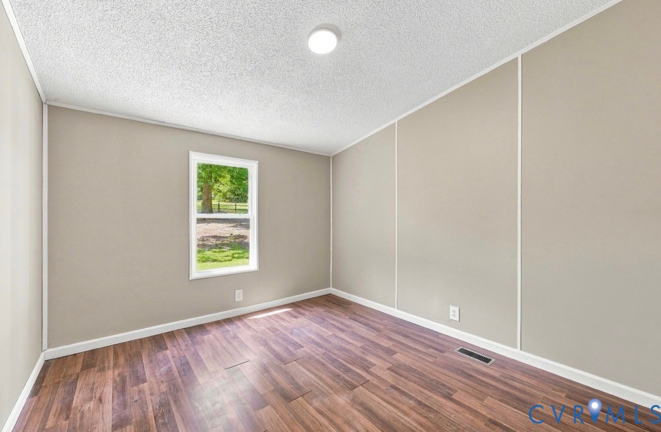 977 Burchs Mill Road Urbanna, VA 23175 - Photo 19 of 38 Wood colored laminate flooring, neutral wall tones