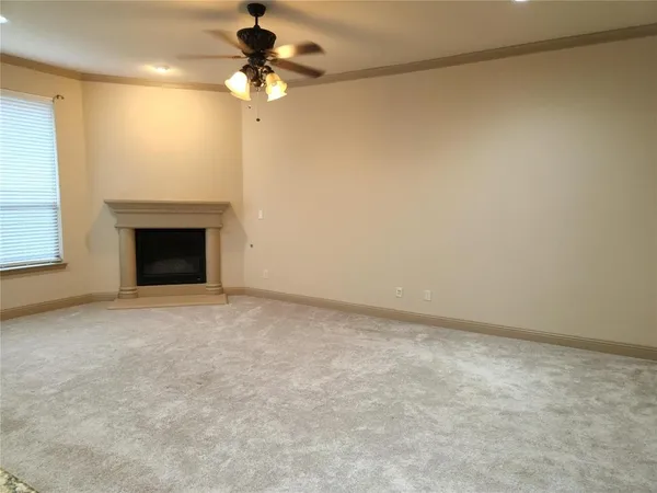 a view of an empty room with a fireplace