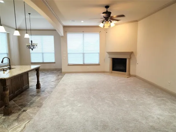 a view of a kitchen with a sink and a fireplace