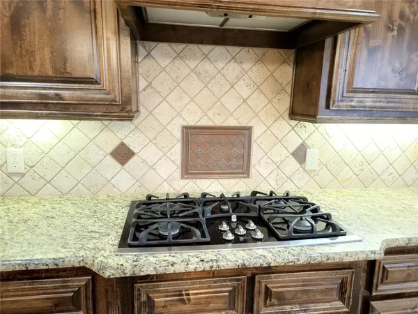 a kitchen with a stove and a shower