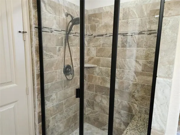 a bathroom with a glass shower door