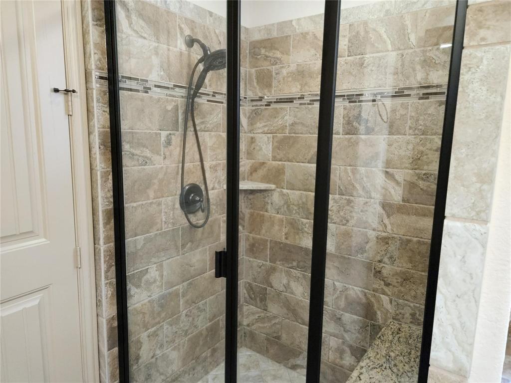 1208 Melcer Street Plano, TX 75074 - Photo 23 of 37 a bathroom with a glass shower door