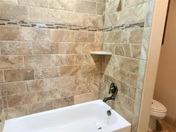 a bathroom with a white bathtub