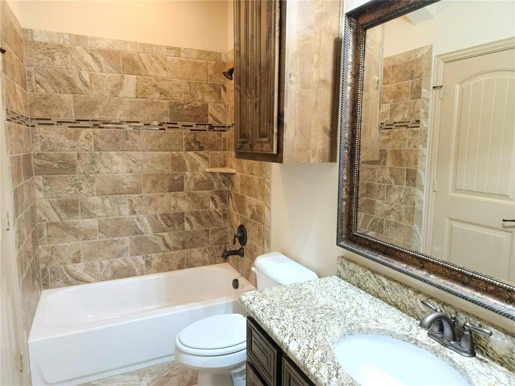 1208 Melcer Street Plano, TX 75074 - Photo 33 of 37 a bathroom with a granite countertop bathtub shower sink vanity and toilet