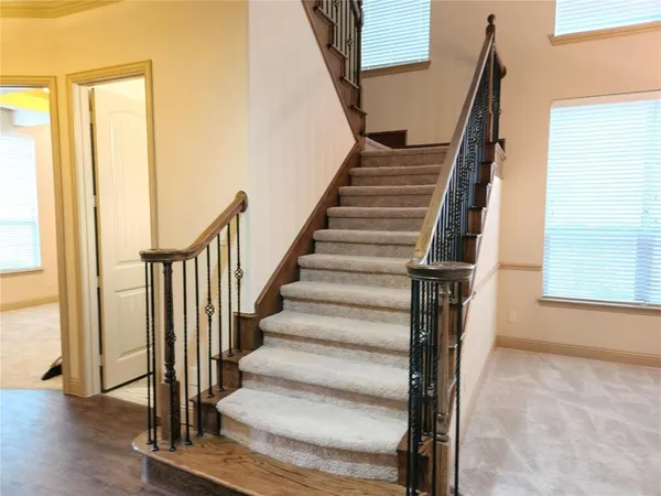 a view of staircase with wooden floor and windows